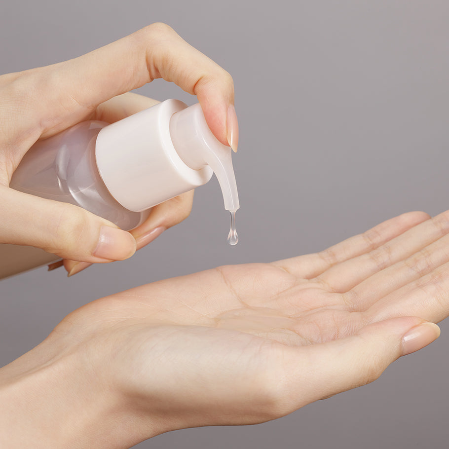 A drop of Sulwhasoo Gentle Cleansing Oil being dispensed onto a hand, showing its lightweight, silky texture.