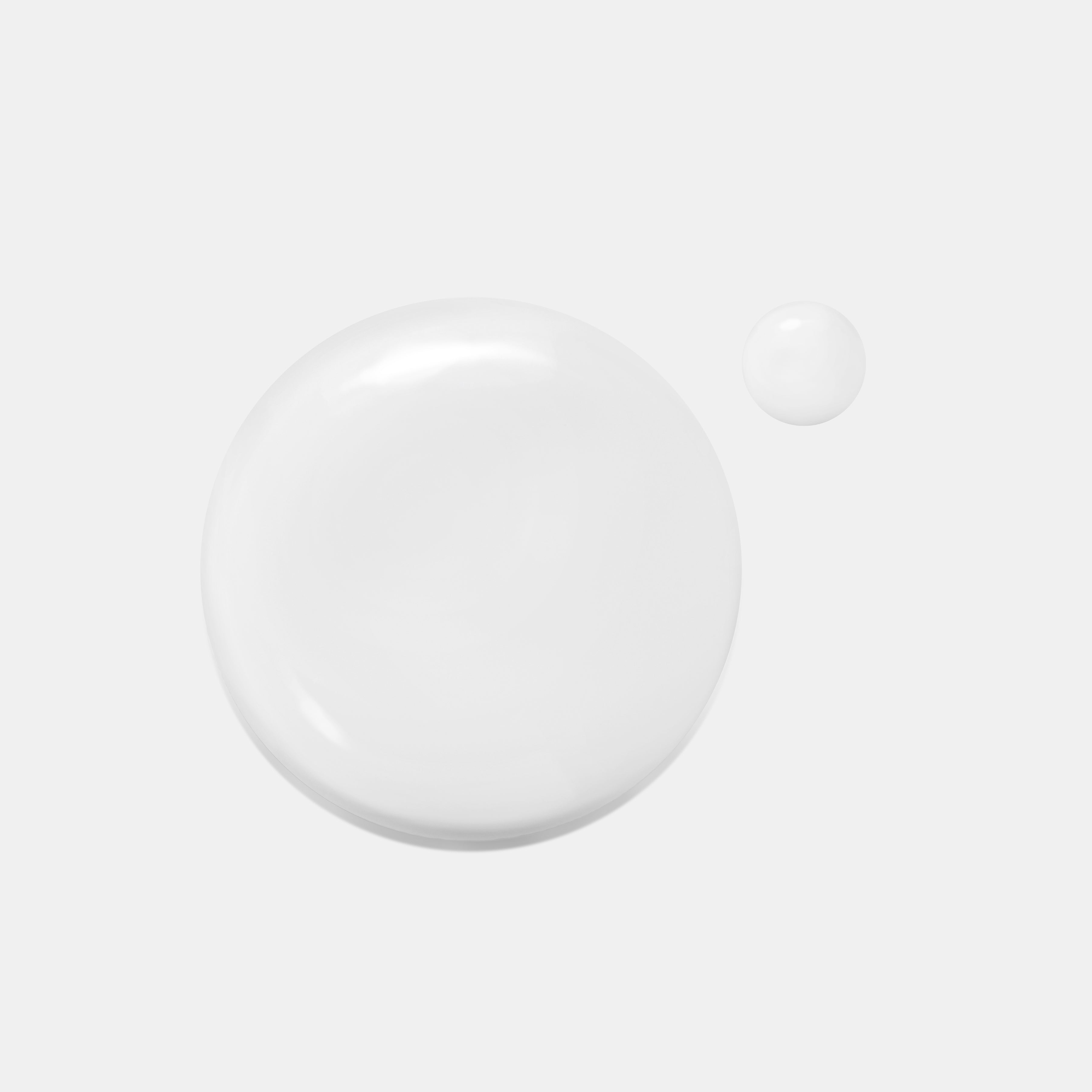 A smooth, creamy white drop of Sulwhasoo's Concentrated Ginseng Brightening Spot Ampoule, shown alongside a smaller droplet, demonstrates the lightweight texture of this brightening serum designed to improve dull skin and reduce dark spots.